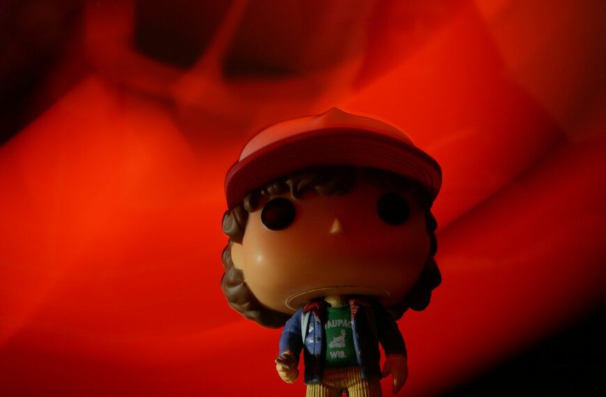 a small toy with a hat and scarf on