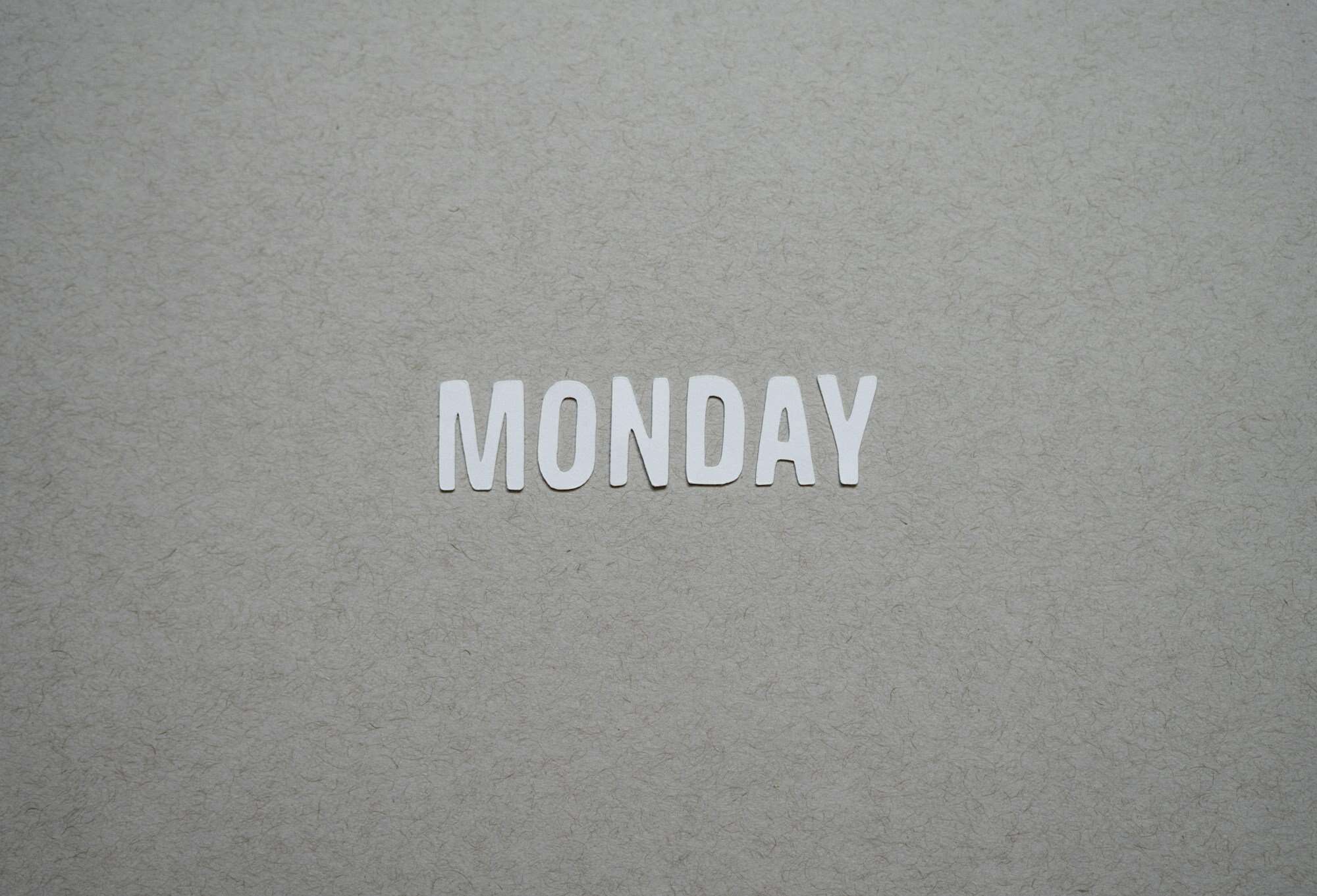 the word monday is cut out of white paper