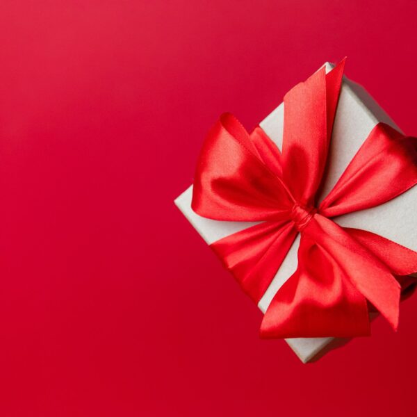 a white box with a red bow on a red background