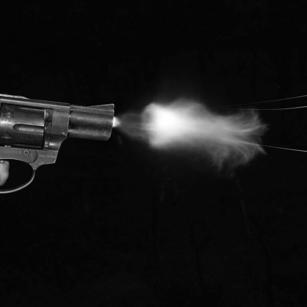 silver and black revolver on black surface