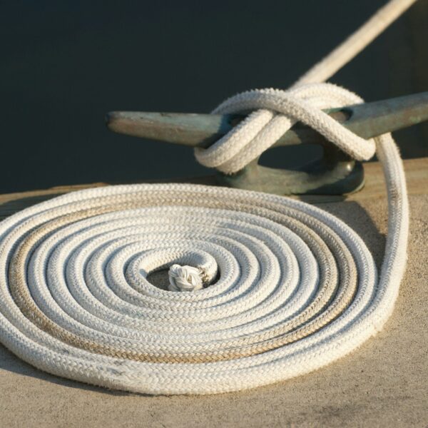 A close up of a white rope on a dock