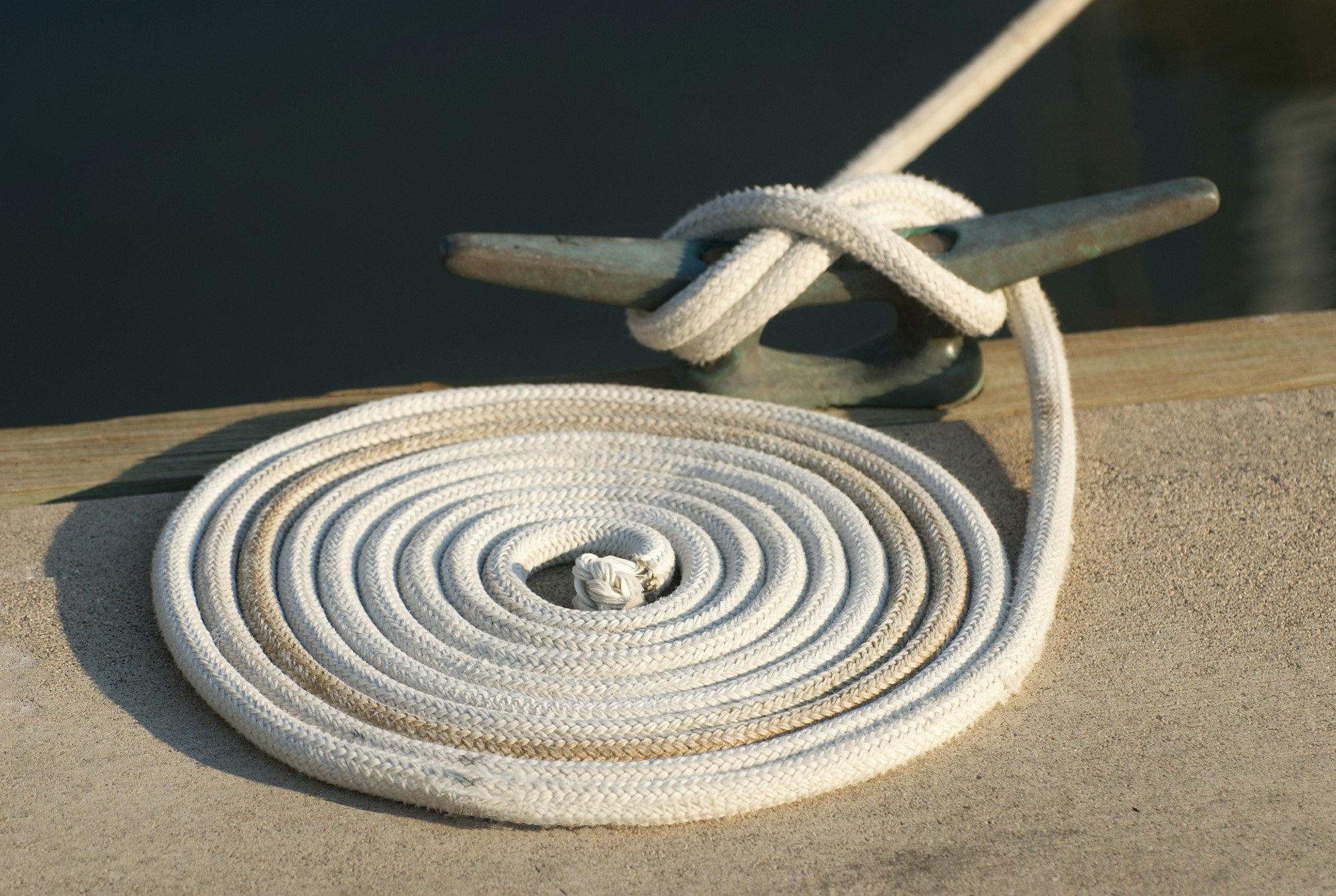 A close up of a white rope on a dock